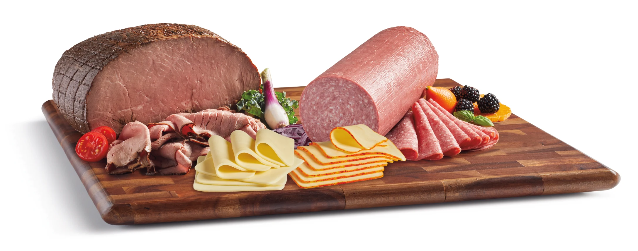 Roast beef, salami, sliced cheeses and deli meats on a wooden cutting board